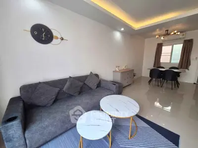 Modern living room with stylish furniture and elegant lighting, perfect for relaxation and entertaining.