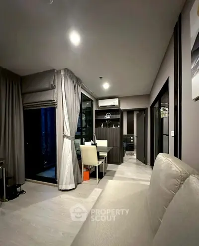 Modern living room with elegant decor and large windows for natural light.