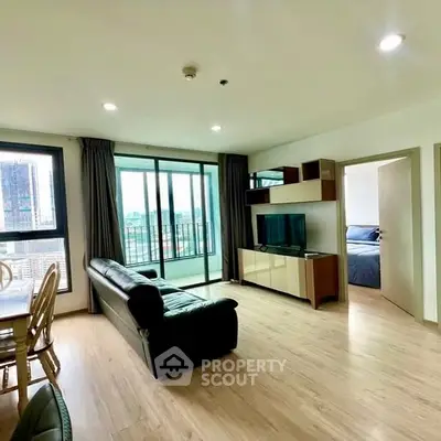 Spacious living room with city view and modern furnishings