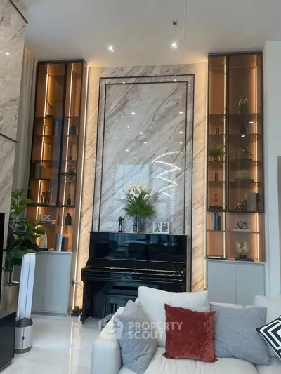 Luxurious living room with elegant marble wall and grand piano, featuring modern lighting and stylish decor.