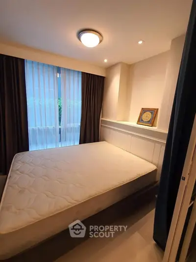 Cozy bedroom with natural light and modern decor in a stylish apartment.
