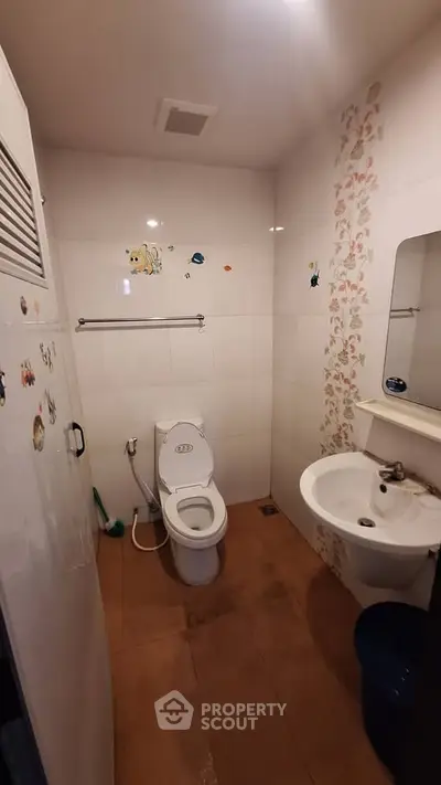 Cozy bathroom with playful wall decals and modern fixtures, perfect for a family home.