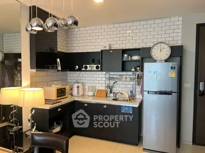 Modern kitchen with sleek black cabinets and stainless steel appliances