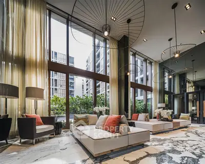 Luxurious modern living room with floor-to-ceiling windows and elegant decor in a high-end apartment building.
