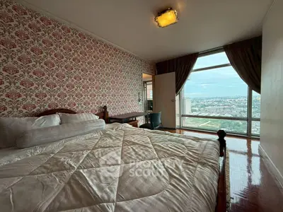 Spacious bedroom with stunning city view and elegant wallpaper design.