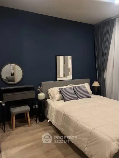 Modern bedroom with stylish decor and cozy ambiance, featuring a comfortable bed and elegant furnishings.