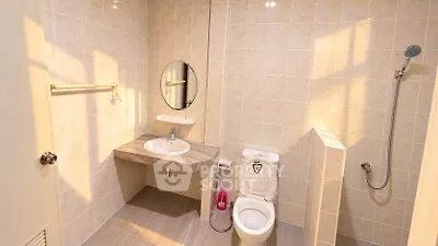 Modern bathroom with sleek fixtures and neutral tiles