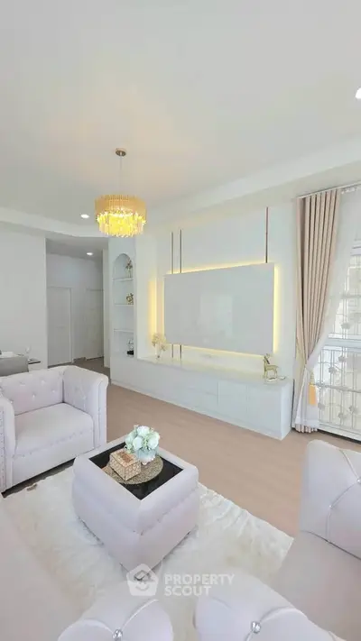 Luxurious modern living room with elegant decor and plush seating in a bright, airy space.