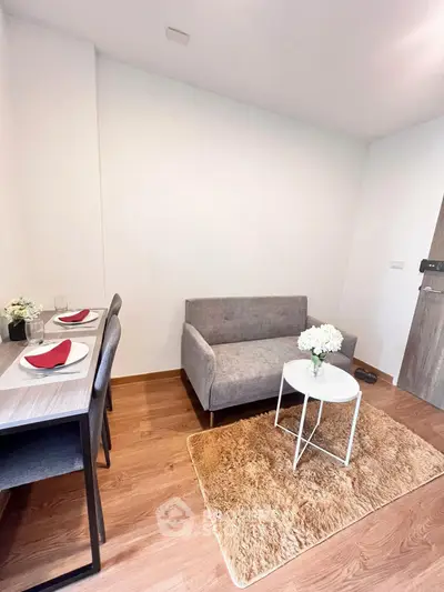 Cozy living room with modern decor and dining area, perfect for urban living.