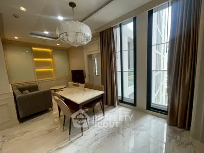 Luxurious dining area with marble flooring and elegant chandelier in modern apartment