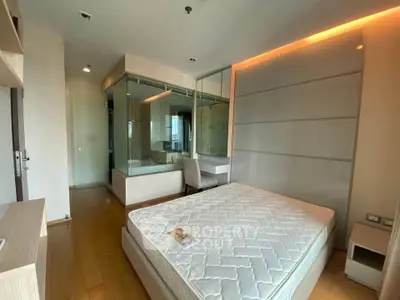 Modern bedroom with glass-enclosed bathroom and sleek design