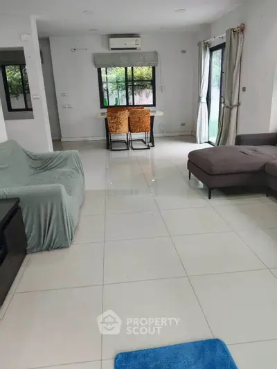 Spacious living room with modern furniture and large windows for natural light.