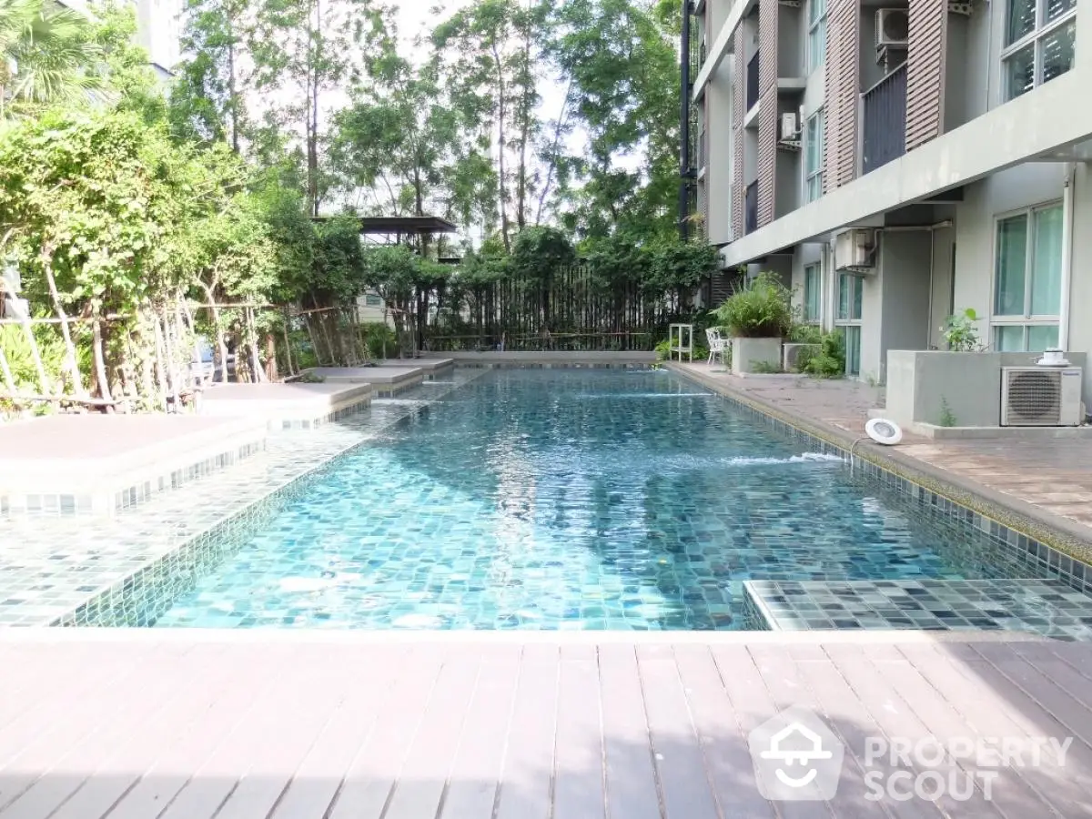 Luxurious residential pool area with modern design and lush greenery