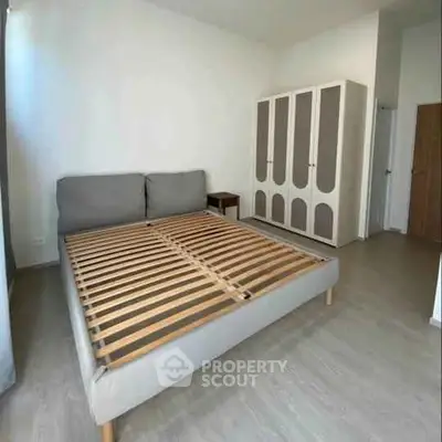 Spacious bedroom with modern bed frame and stylish wardrobe