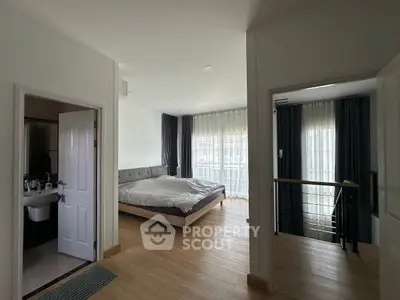Spacious bedroom with modern decor and natural light