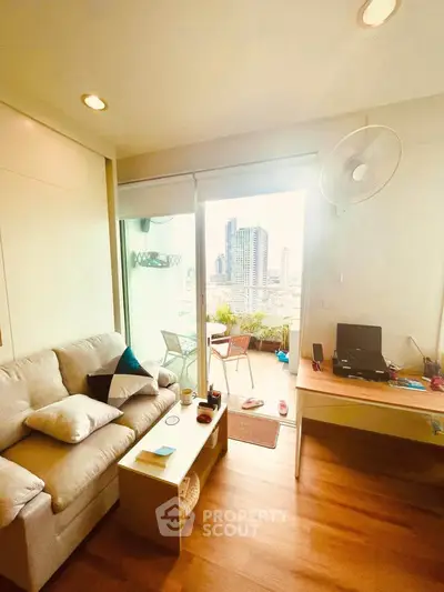 Cozy living room with city view and balcony access in modern apartment.