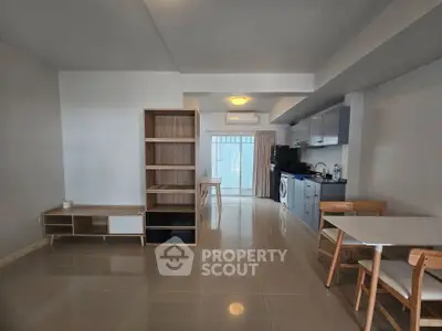 Spacious modern living area with open kitchen and stylish furniture