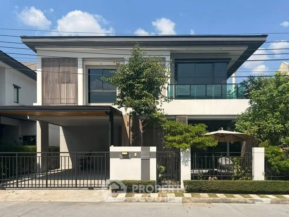 Modern two-story house with sleek design and lush garden