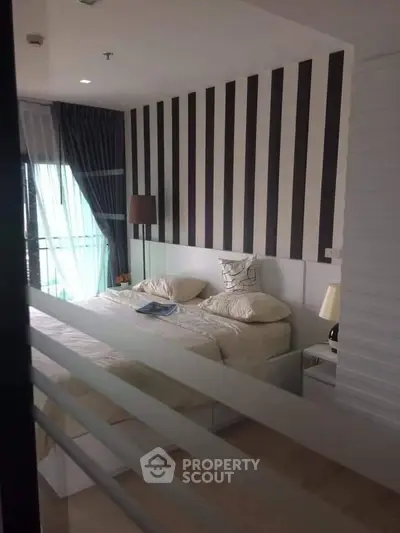 Modern bedroom with stylish striped accent wall and cozy decor