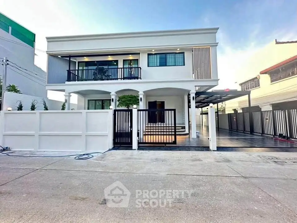 Stunning modern two-story house with sleek design and spacious driveway in a serene neighborhood.