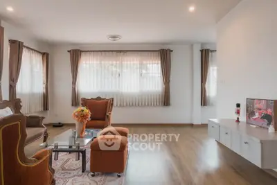 Spacious living room with elegant furniture and large windows for natural light.