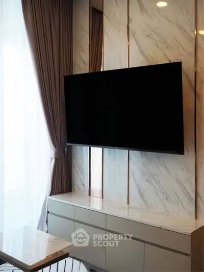 Luxurious modern living room with marble accents and large flat-screen TV