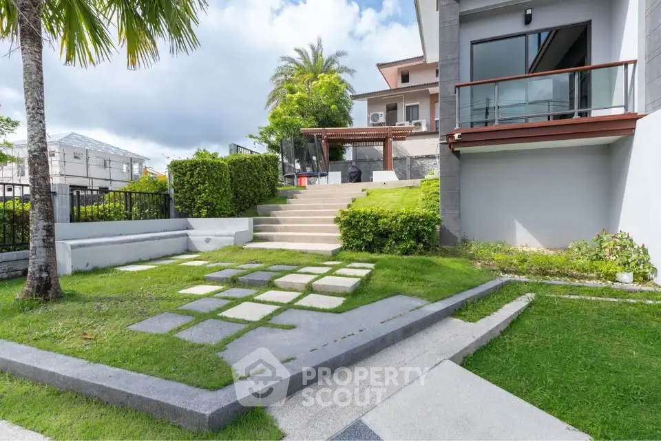 Modern home exterior with lush garden and stylish patio area