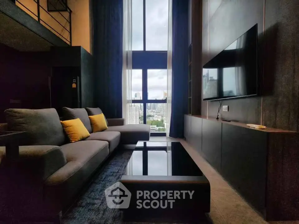 Luxurious high-ceiling living room with modern decor and stunning city view.