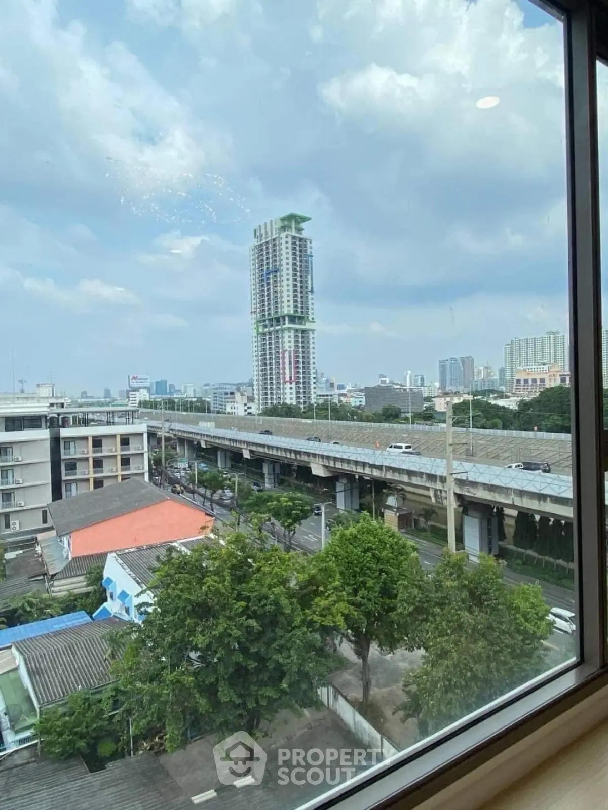 Stunning cityscape view from high-rise window showcasing urban skyline and modern architecture.