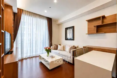 Elegant living room with modern decor, large window, and cozy seating area.