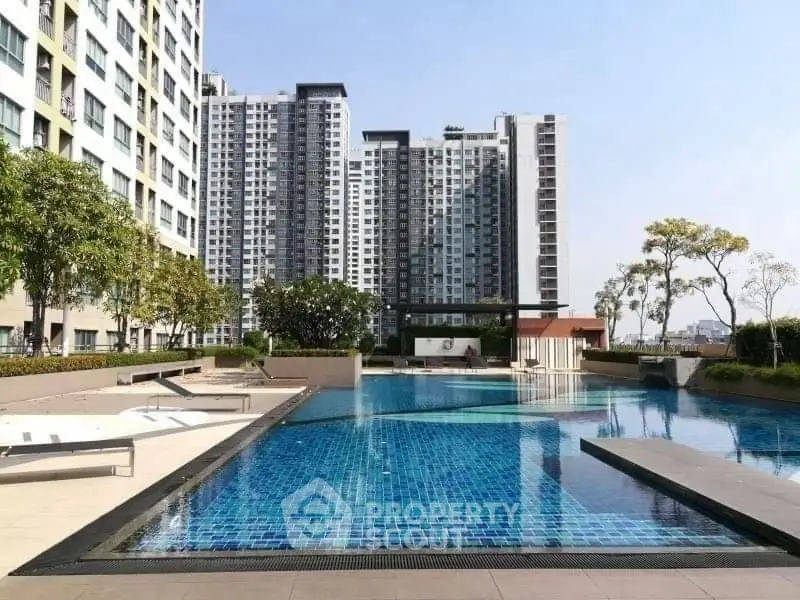 Luxurious condominium with stunning pool and modern architecture in urban setting.