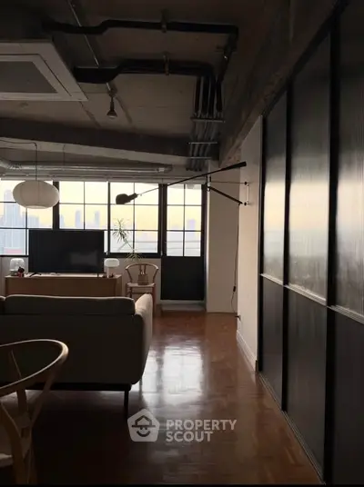 Stylish industrial-style living room with city view and modern furniture