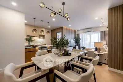 Luxurious open-plan living and dining area with modern decor and elegant lighting.