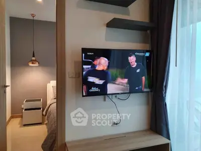 Modern bedroom with wall-mounted TV and stylish decor