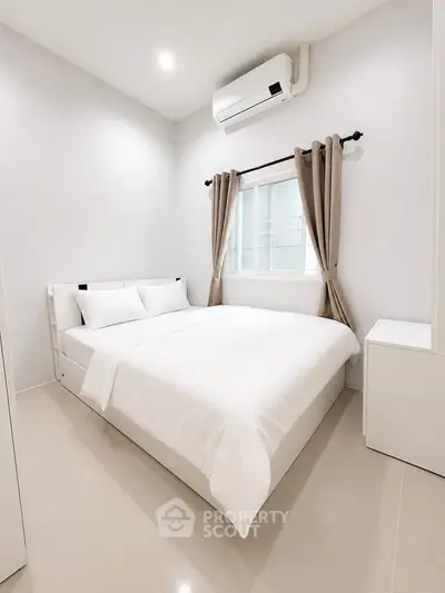 Modern minimalist bedroom with white decor and air conditioning