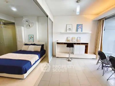 Modern studio apartment with cozy bedroom and stylish workspace