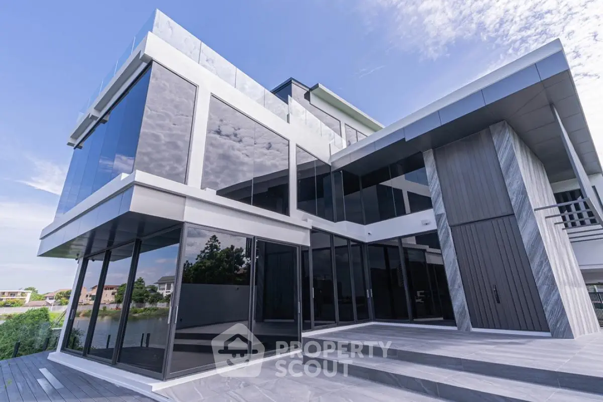 Modern luxury home with sleek glass facade and spacious outdoor area