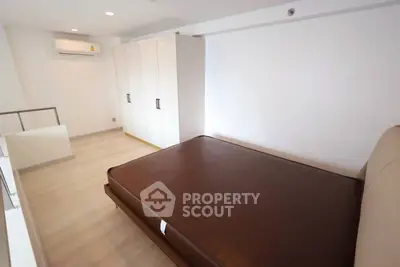 Spacious bedroom with modern design and ample storage in a stylish apartment.