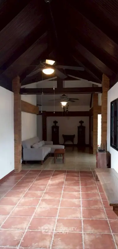 Charming rustic living room with high wooden ceiling and cozy seating area.