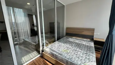 Modern bedroom with glass partition and natural light in stylish apartment
