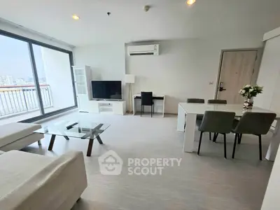 Modern living room with city view, sleek furniture, and natural light.