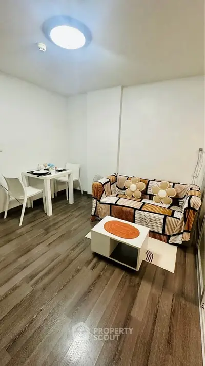 Cozy living room with modern decor and dining area, perfect for relaxation.