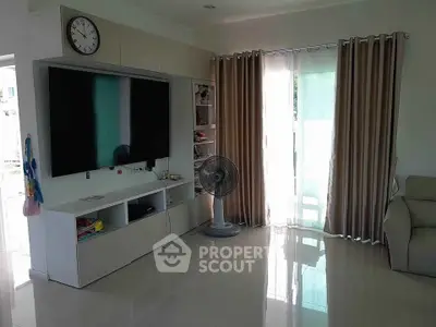 Modern living room with sleek TV setup and natural light