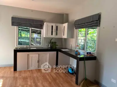 Charming kitchen with ample natural light and modern design, featuring sleek countertops and stylish cabinetry.