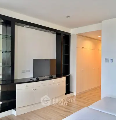 Modern living room with sleek built-in entertainment unit and ample storage space.