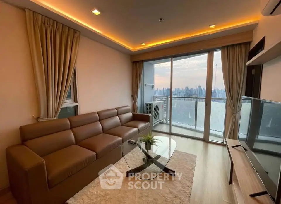 Modern living room with city view, featuring a sleek brown sofa and glass coffee table, perfect for urban living.