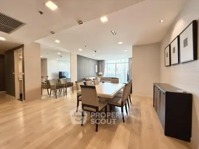 Spacious modern living and dining area with elegant decor and large windows.