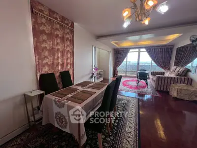 Spacious living room with elegant dining area and panoramic city view.