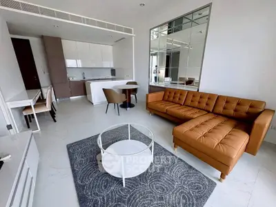 Modern living room with stylish furniture and open kitchen layout in a contemporary apartment.