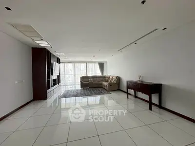 Spacious modern living room with sleek tile flooring and large windows.